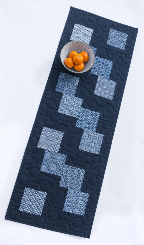 Shweshwe indigo cotton fabrics from South Africa and Japanese sashing fabric make this table runner irresistible.  Kit includes all fabric for the top and binding. Pattern included. 16.5 x 48 $27.00 Fabrics in kits are subject to change