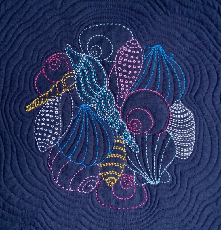 Colorful Seashell Sashiko panel pre-printed on dark blue fabric. Includes instructions. 14 x14. Thread not included.  We have the threads, you need one package of each. Olympus #1,8,16,17,21,24,27.$24