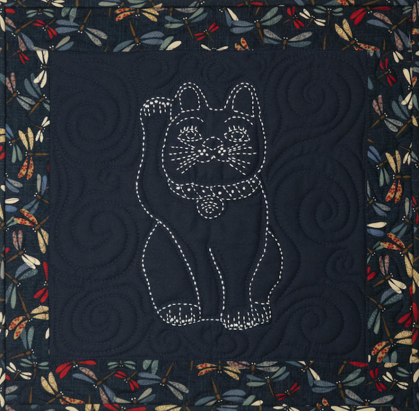 Lucky Cat (Maneki-neko) Sashiko pattern pre-printed with solid lines. Dragonfly fabric and one skein of thread not included.  Pattern washes out. Each square is 12.5" Navy- Sale $8.76 was $10.95