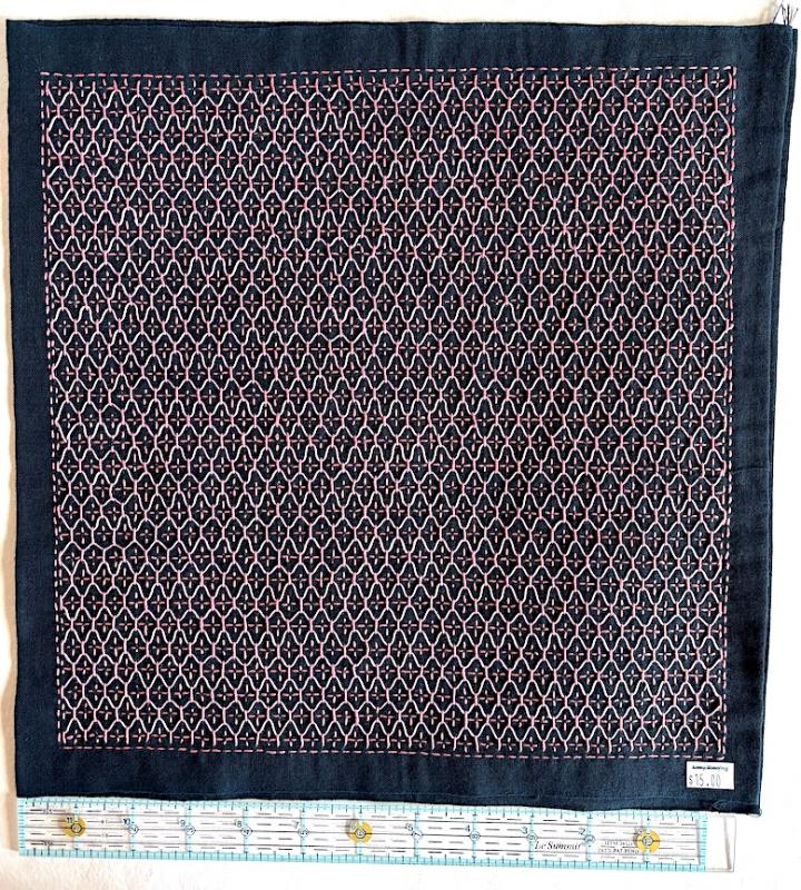 Kikko flower vase with pink and lavender thread on navy Sashiko fabric. Stitched through 1 layer. Has a solid navy back. $15.00