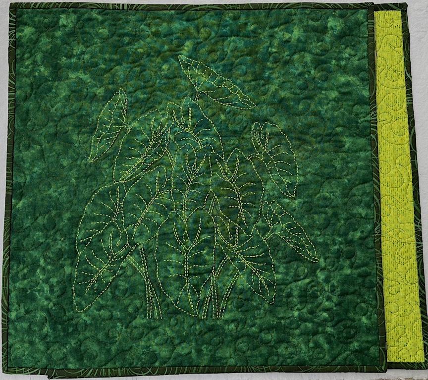 Taro plant wall hanging with bright green Sashiko thread hand stitched. Background is machine quilted on green fabric with sleeve for hanging on back. 18 x 18". $50.00