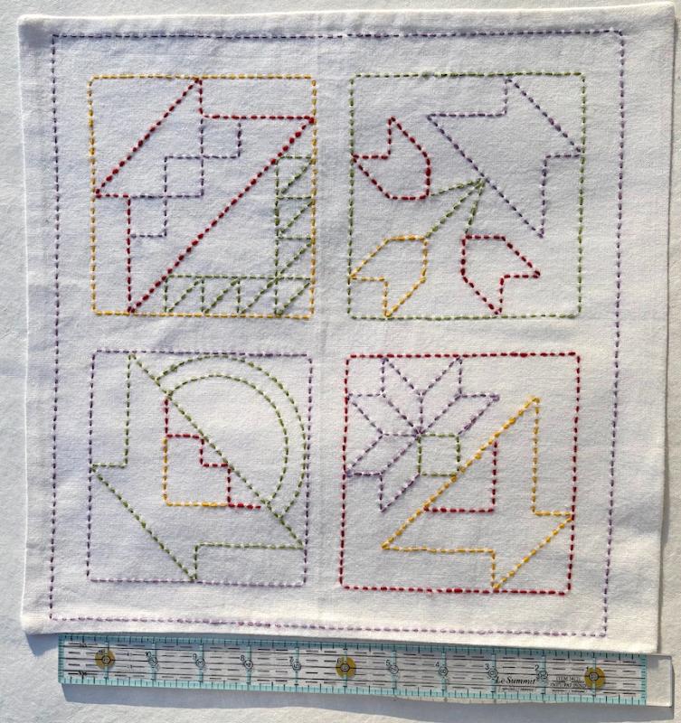 Flower baskets-red, green, purple & yellow threads on white Sashiko fabric. Stitched through 1 layer. Has a solid white back. Edges sewn. ready for a pillow $10.00